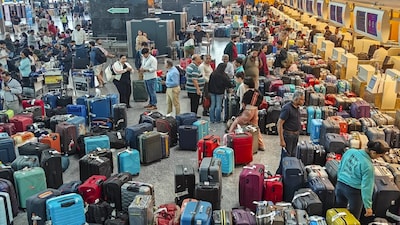 Bengaluru: Stranded passengers search for their luggage near a counter after IndiGo cancelled more than 400 flights, at the Kempegowda International Airport, in Bengaluru, Karnataka, Friday, Dec. 5, 2025. (PTI Photo/Shailendra Bhojak) (PTI12_05_2025_000028A)