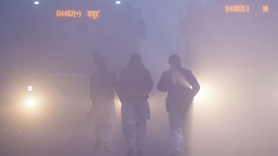 School children brave dense fog on a winter morning, at Mayur Vihar area, in New Delhi, Saturday, Dec. 20, 2025. Visibility plunged across parts of Delhi on Saturday morning, with buildings and flyovers fading into a grey blur amid dense fog, as the capital�s AQI edged closer to the �severe� category at 384. (PTI Photo/Ravi Choudhary) 