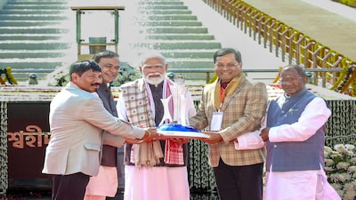 **EDS: THIRD PARTY IMAGE** In this image posted on Dec. 21, 2025, from left, Assam Minister Atul Bora, Chief Minister Himanta Biswa Sarma, Prime Minister Narendra Modi, Union Minister Sarbananda Sonowal and state Governor Lakshman Prasad Acharya at the 'Swahid Smarak Kshetra', in Guwahati. (@himantabiswa/X via PTI Photo) (PTI12_21_2025_000083B)