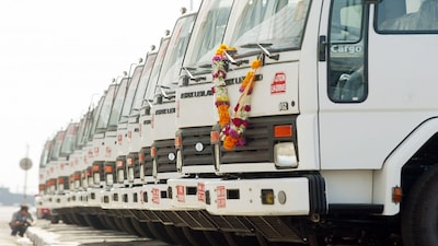 A photographer takes pictures of trucks headed for Iraq at Bombay port, February 7, 2004. Indian commercial vehicles manufacturer 'Ashok Leyland' are exporting 3322 trucks to Iraq valued at $46 million, under the U.N. Oil for Food Programme. REUTERS/Arko Datta  AD/DL