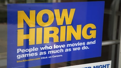 A help wanted sign hangs on the door of a Blockbuster movie and game store in Golden, Colorado September 17, 2009.  The number of U.S. workers filing new claims for jobless benefits unexpectedly fell last week data showed, while there was a rise in the number of those still on the benefit rolls after an initial week of aid. REUTERS/Rick Wilking (UNITED STATES BUSINESS EMPLOYMENT)