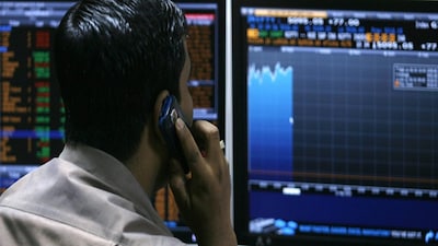 A broker looks at computer screens at a stock brokerage firm in Mumbai May 10, 2010. Indian shares extended gains to more than 2 percent by late morning on Monday, helped by strong Asian peers and investor relief in the wake of a $1 trillion rescue package to contain the Greek crisis and calm world markets.  REUTERS/Arko Datta (INDIA - Tags: BUSINESS)