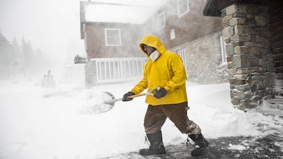 Craig Bentley, caretaker of Soda Springs Station, shovels snow in Soda Springs, California, November 24, 2015. A winter storm has hit Northern California dropping rain and snow. REUTERS/Max Whittaker