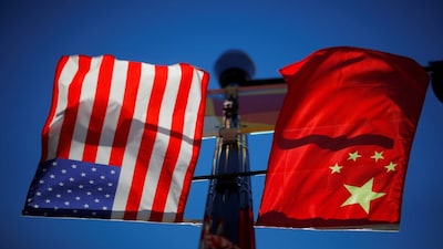 The flags of the United States and China fly from a lamppost in the Chinatown neighborhood of Boston, Massachusetts, U.S., November 1, 2021.   REUTERS/Brian Snyder