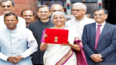 India's Finance Minister Nirmala Sitharaman holds up a folder with the Government of India's logo as she leaves her office to present the union budget in the parliament in New Delhi, India, July 23, 2024. REUTERS/Altaf Hussain