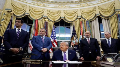 U.S. President Donald Trump listens to a question from a reporter prior to signing an executive order on AI next to Sriram Krishnan, Senior White House Policy Advisor on Artificial Intelligence, U.S. Senate Commerce Committee Chairman Ted Cruz (R-TX), U.S. Commerce Secretary Howard Lutnick, and David O. Sacks, Chair of the President's Council of Advisors on Science and Technology, in the Oval Office at the White House in Washington, D.C., U.S. December 11, 2025. REUTERS/Al Drago