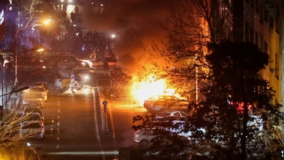 Cars burn in a street during a protest over the collapse of the currency's value, in Tehran, Iran, January 8, 2026. Stringer/WANA (West Asia News Agency) via REUTERS ATTENTION EDITORS - THIS PICTURE WAS PROVIDED BY A THIRD PARTY     TPX IMAGES OF THE DAY