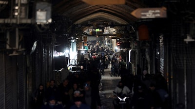 FILE PHOTO: People walk past closed shops, following protests over a plunge in the currency's value, in the Tehran Grand Bazaar in Tehran, Iran, December 30, 2025. Majid Asgaripour/WANA (West Asia News Agency) via REUTERS ATTENTION EDITORS - THIS PICTURE WAS PROVIDED BY A THIRD PARTY/File Photo