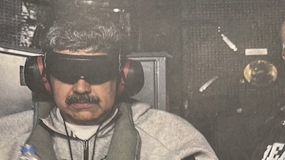 A photograph which U.S. President Donald Trump posted on his Truth Social account shows what he describes as Venezuelan President "Nicolas Maduro on board the USS Iwo Jima" amphibious assault ship, currently in the Caribbean Sea January 3, 2026. The image appears to be taken from a printed photograph, as white edging can be seen around the image. What appears to be the letters DEA can be seen on a black uniformed person next to Venezuelan president Maduro. U.S. president Trump said DEA officials were involved in the operation. Verifying the location was not immediately possible as the photograph is tightly cropped. But the patterning of grey hairs within Maduro's mustache matched recent imagery of him. @realDonaldTrump/Handout via REUTERS  THIS IMAGE HAS BEEN SUPPLIED BY A THIRD PARTY. THIS PICTURE WAS PROCESSED BY REUTERS TO ENHANCE QUALITY. AN UNPROCESSED VERSION HAS BEEN PROVIDED SEPARATELY.     TPX IMAGES OF THE DAY