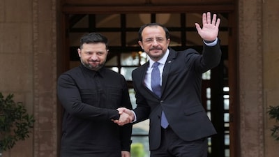 Ukraine's President Volodymyr Zelenskiy is welcomed by his Cypriot counterpart Nikos Christodoulides before their meeting at the presidential palace in Nicosia, Cyprus, Wednesday, Jan. 7, 2026. Petros Karadjias/Pool via REUTERS