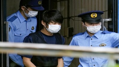 Tetsuya Yamagami, Suspected of killing former Japanese premier Shinzo Abe, is escorted by police officers as he is taken to prosecutors, at Nara-nishi police station in Nara, western Japan, in this photo taken by Kyodo July 10, 2022. Photo Kyodo via REUTERS