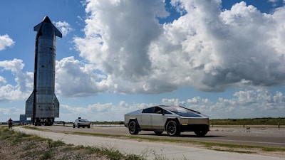 Tesla Cyber Trucks lead the way as the SpaceX Starship spacecraft rolls out toward the launch pad before its 11th test flight from the company's complex in Starbase, Texas, U.S., October 11, 2025. REUTERS/Steve Nesius