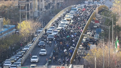 Protesters march in downtown Tehran, Iran, Monday, Dec. 29, 2025. (Fars News Agency via AP)