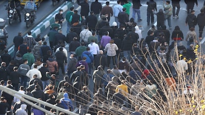 Protesters march in downtown Tehran, Iran, Monday, Dec. 29, 2025. (Fars News Agency via AP)