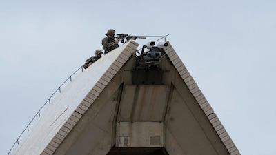 Security with rifles are positioned on the sails of the Sydney Opera House ahead of a National Day of Mourning event in Sydney, Thursday, Jan. 22, 2026, in response to two shooters killing 15 people at a Jewish festival in Sydney last month. (AP Photo/Rick Rycroft)