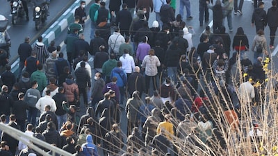 Protesters march in downtown Tehran, Iran, Monday, Dec. 29, 2025. (Fars News Agency via AP)
