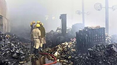 Fire brigade personnel douse a fire at a warehouse, in Kolkata. (PTI)