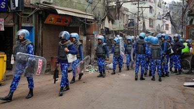 Rapid Action Force (RAF) personnel patrol after violence erupted during a court-mandated demolition on land adjoining the Syed Faiz Elahi Mosque and a nearby graveyard, in New Delhi, Wednesday, Jan. 7, 2025. At least five police personnel were injured after some people allegedly pelted stones and glass bottles at the force after the drive near the mosque turned violent. (PTI Photo/Shahbaz Khan) 