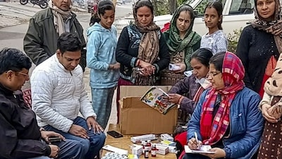 A health department team conducts medical check-ups and distributes medicines amid a contaminated water crisis, in Greater Noida, Uttar Pradesh, Thursday, Jan. 8, 2026. (PTI Photo)