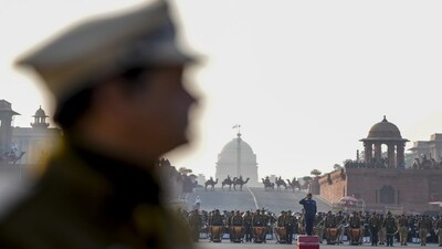 New Delhi: A security personnel stands in the foreground as Army bands perform during rehearsals for the Beating Retreat ceremony at Vijay Chowk, in New Delhi, Wednesday, Jan. 21, 2026. (PTI Photo/Salman Ali)(PTI01_21_2026_000237A)