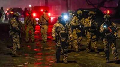 Members of law enforcement gather, as tensions rise after federal law enforcement agents were involved in a shooting incident, a week after a U.S. Immigration and Customs Enforcement (ICE) agent fatally shot Renee Nicole Good, in north Minneapolis, Minnesota, U.S., January 15, 2026. REUTERS/Ryan Murphy 