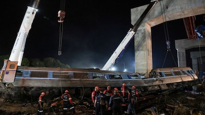 Rescue workers search the site where a train was derailed when a construction crane collapsed and fell onto its carriages, causing several casualties, in Sikhio district, Nakhon Ratchasima province, Thailand, January 14, 2026. REUTERS/Chalinee Thirasupa     TPX IMAGES OF THE DAY