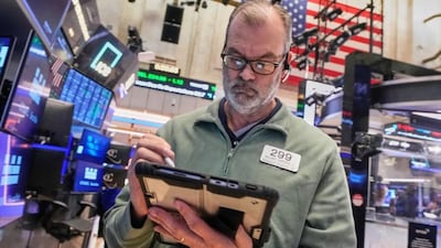 Trader William Lawrence works on the floor of the New York Stock Exchange, Monday, Jan. 26, 2026. (AP Photo/Richard Drew)