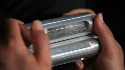 Ahamad Alavi, head of the Astan Qods Razavi museum, holds a sample of enriched uranium during a ceremony to mark Iran's successful production of enriched uranium in Mashad, 924 km (574 miles) east of Tehran April 11, 2006. Iran's President Mahmoud Ahmadinejad said on Tuesday Iran had joined the group of countries possessing nuclear technology and was determined to achieve industrial-scale uranium enrichment.  REUTERS/Stringer