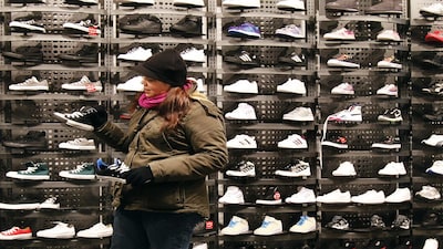 A woman shops for sneakers at a shoe store in New York December 14, 2010. The U.S. consumer price index for November will be released December 15, 2010. REUTERS/Shannon Stapleton   (UNITED STATES - Tags: BUSINESS)