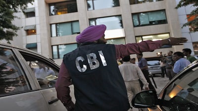 A Central Bureau of Investigation (CBI) official gestures outside the New Delhi office of the Abhijeet Group, which owns Jas Infrastructure, after conducting a raid on September 4, 2012. Federal law enforcement officials raided offices and homes in 10 cities across India on Tuesday as part of an investigation into irregularities in the award of coalfield concessions to private and state companies that has sparked a political crisis. REUTERS/Mansi Thapliyal (INDIA - Tags: BUSINESS ENERGY POLITICS)