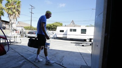 Parkinson's patient Ron Addison makes his way home after working out with trainer in Costa Mesa, California. (Image Reuters file)