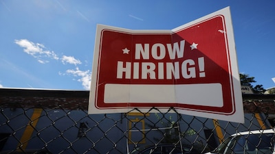 A "now hiring" sign is displayed outside Taylor Party and Equipment Rentals in Somerville, Massachusetts, U.S., September 1, 2022.     REUTERS/Brian Snyder