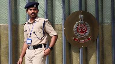A security personnel walks past a gate of the office of Directorate of Enforcement in New Delhi, India, March 13, 2024. REUTERS/Anushree Fadnavis