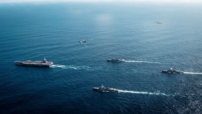 The U.S. Navy’s Gerald R. Ford Carrier Strike Group, including the flagship USS Gerald R. Ford, USS Winston S. Churchill, USS Mahan and USS Bainbridge, sail towards the Caribbean Sea under F/A-18E/F Super Hornets and a U.S. Air Force B-52 Stratofortress, in the Atlantic Ocean November 13, 2025.  U.S. Navy/Petty Officer 3rd Class Tajh Payne/Handout via REUTERS. THIS IMAGE HAS BEEN SUPPLIED BY A THIRD PARTY