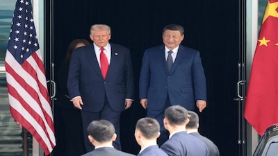 FILE PHOTO: U.S. President Donald Trump and Chinese President Xi Jinping walk as they leave after a bilateral meeting at Gimhae International Airport, on the sidelines of the Asia-Pacific Economic Cooperation (APEC) summit, in Busan, South Korea, October 30, 2025. REUTERS/Evelyn Hockstein/File Photo