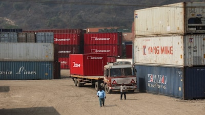 Men walk inside a shipping container warehouse in Navi Mumbai, India, February 4, 2026. REUTERS/Francis Mascarenhas