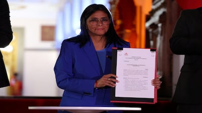Venezuela's interim President Delcy Rodriguez holds the text of the amnesty law meant to grant immediate clemency to individuals jailed for participating in political protests following its approval, at Miraflores Palace, in Caracas, Venezuela, February 19, 2026. REUTERS/Leonardo Fernandez Viloria