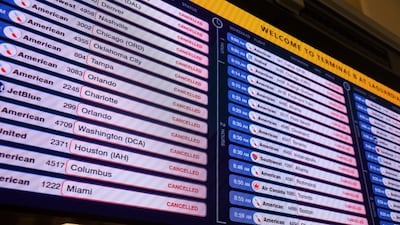 A departure board dispays information about cancelled flights, during a winter storm at LaGuardia Airport in New York City, U.S., February 23, 2026. REUTERS/Shannon Stapleton