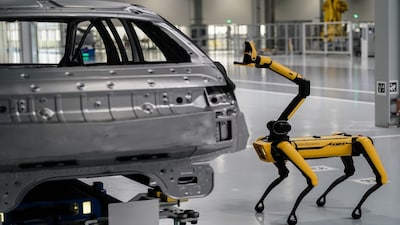 A Boston Dynamics Spot robot uses a camera to scan for defects on the body of a car at the Hyundai Metaplant electric vehicle manufacturing facility in Ellabell, Georgia. Photographer: Elijah Nouvelage/Bloomberg