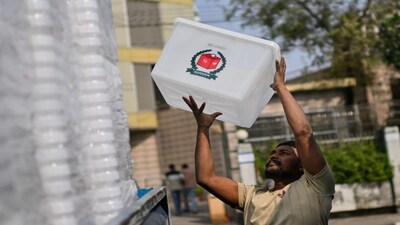 A worker loads an empty ballot box onto a vehicle for transport to polling centers ahead of the national elections in Dhaka, Bangladesh. (AP Photo)