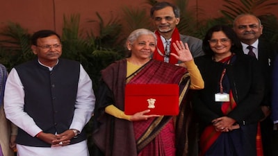 India's Finance Minister Nirmala Sitharaman waves as she holds a red folder bearing the Government of India's emblem, while posing with her officials before leaving her office to present the annual federal budget in parliament, in New Delhi, India, February 1, 2026. REUTERS/Altaf Hussain     TPX IMAGES OF THE DAY