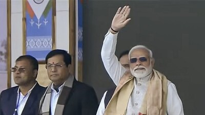 **EDS: THIRD PARTY IMAGE** In this screenshot from a video released on Feb. 14, 2026, Prime Minister Narendra Modi with Union Minister Sarbananda Sonowal during an aerial show featuring IAF's fighter jets and transport helicopters at the Emergency Landing Facility (ELF), in Dibrugarh district, Assam. (@NarendraModi/YT via PTI Photo)(PTI02_14_2026_000089B)