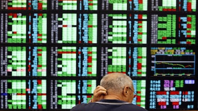 A man monitors stock market prices inside a brokerage in Taipei August 8, 2011. Taiwan stocks plunged 3.82 percent to a 13-month low closing low on Monday, joining other declining Asian bourses after a downgrade of the U.S. credit rating. REUTERS/Pichi Chuang (TAIWAN - Tags: BUSINESS IMAGES OF THE DAY)