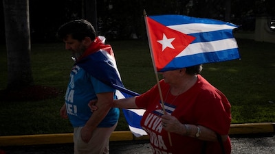 A woman holds a Cuban flag as supporters of U.S President Donald Trump participate in a protest against Cuba's government, in Miami, Florida, U.S., February 28, 2026. REUTERS/Marco Bello