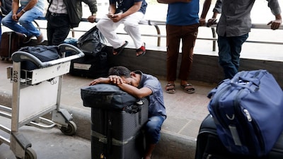 Stranded passengers wait at Hazrat Shahjalal International Airport after flights to Dubai and Bahrain were cancelled, after Iranian strikes, following strikes on Iran launched by the United States and Israel, in Dhaka, Bangladesh, March 1, 2026. REUTERS/Mohammad Ponir Hossain