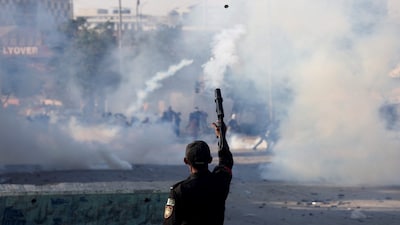 A police officer fires a teargas shell to disperse a protest outside the U.S. and Israeli strikes on Iran that killed Iran's Supreme Leader Ayatollah Ali Khamenei, in Karachi, Pakistan, March 1, 2026. REUTERS/Akhtar Soomro TPX IMAGES OF THE DAY
