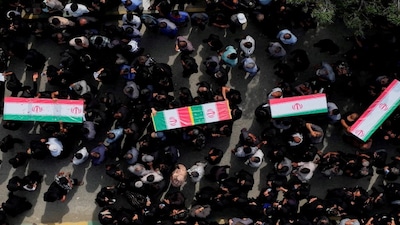 People carry coffins as they attend the funeral of the victims following a reported strike on a school, amid the U.S.-Israeli conflict with Iran, in Minab, Iran, March 3, 2026. Amirhossein Khorgooei/ISNA/WANA (West Asia News Agency) via REUTERS ATTENTION EDITORS - THIS PICTURE WAS PROVIDED BY A THIRD PARTY. TPX IMAGES OF THE DAY     REFILE – REMOVING ATTRIBUTION TO STRIKE