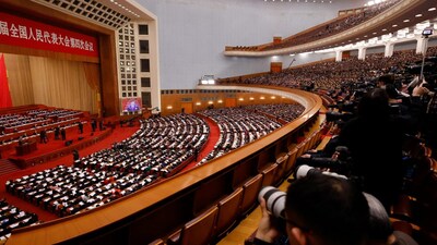 A screen broadcasts Chinese President Xi Jinping as journalists and delegates attend the opening session of the National People's Congress (NPC) at the Great Hall of the People in Beijing, China March 5, 2026. REUTERS/Maxim Shemetov