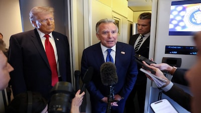 U.S. President Donald Trump listens as Middle East envoy Steve Witkoff speaks to reporters aboard Air Force One on a flight from Dover, Delaware, to Miami, Florida, U.S., March 7, 2026. REUTERS/Kevin Lamarque