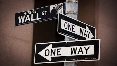 FILE PHOTO: A 'Wall St' sign is seen above two 'One Way' signs in New York August 24, 2015.  Wall Street opened sharply lower on Monday with the Dow Jones industrial average losing more than a 1,000 points following a more-than 8 percent drop in Chinese shares and a selloff in oil and other commodities. REUTERS/Lucas Jackson/File Photo